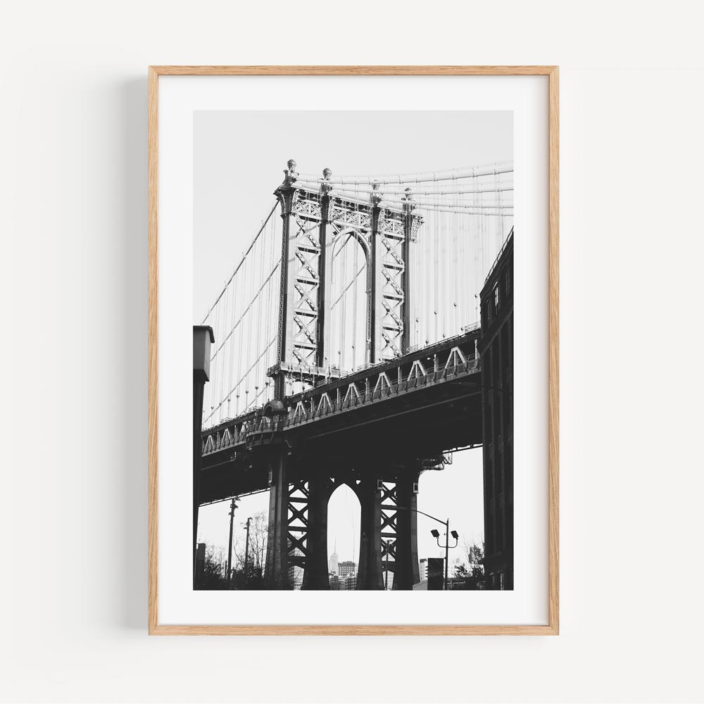 Artistic Perspective: Framed black and white image of the Dumbo Bridge, New York, adding sophistication to any wall decor.
