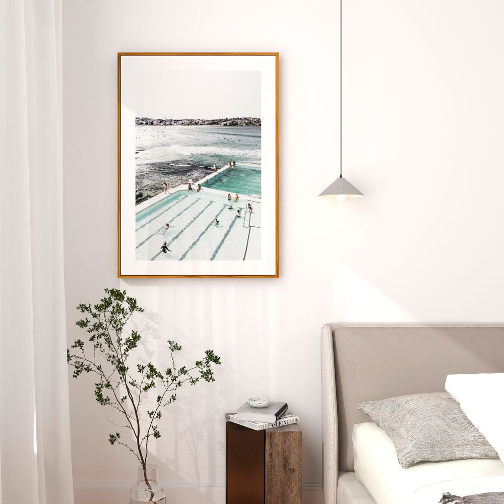 Coastal Charm: Bathers enjoy Bondi Icebergs pool against ocean backdrop, ideal for coastal-inspired wall decor.