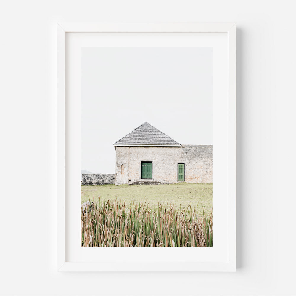 A white framed photo of a building with green shutters - Architecture on Norfolk Island