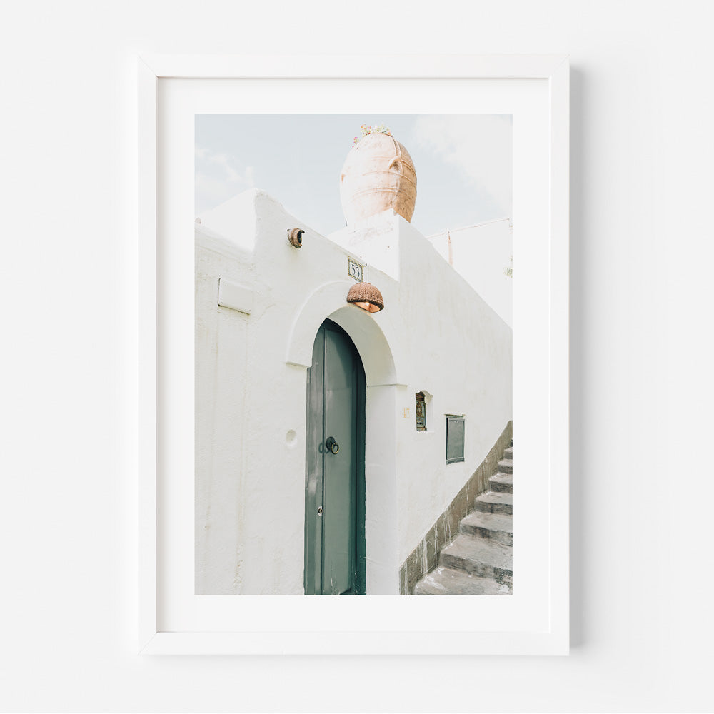 A white framed photo of a doorway and stairs in Positano, Amalfi Coast, Italy