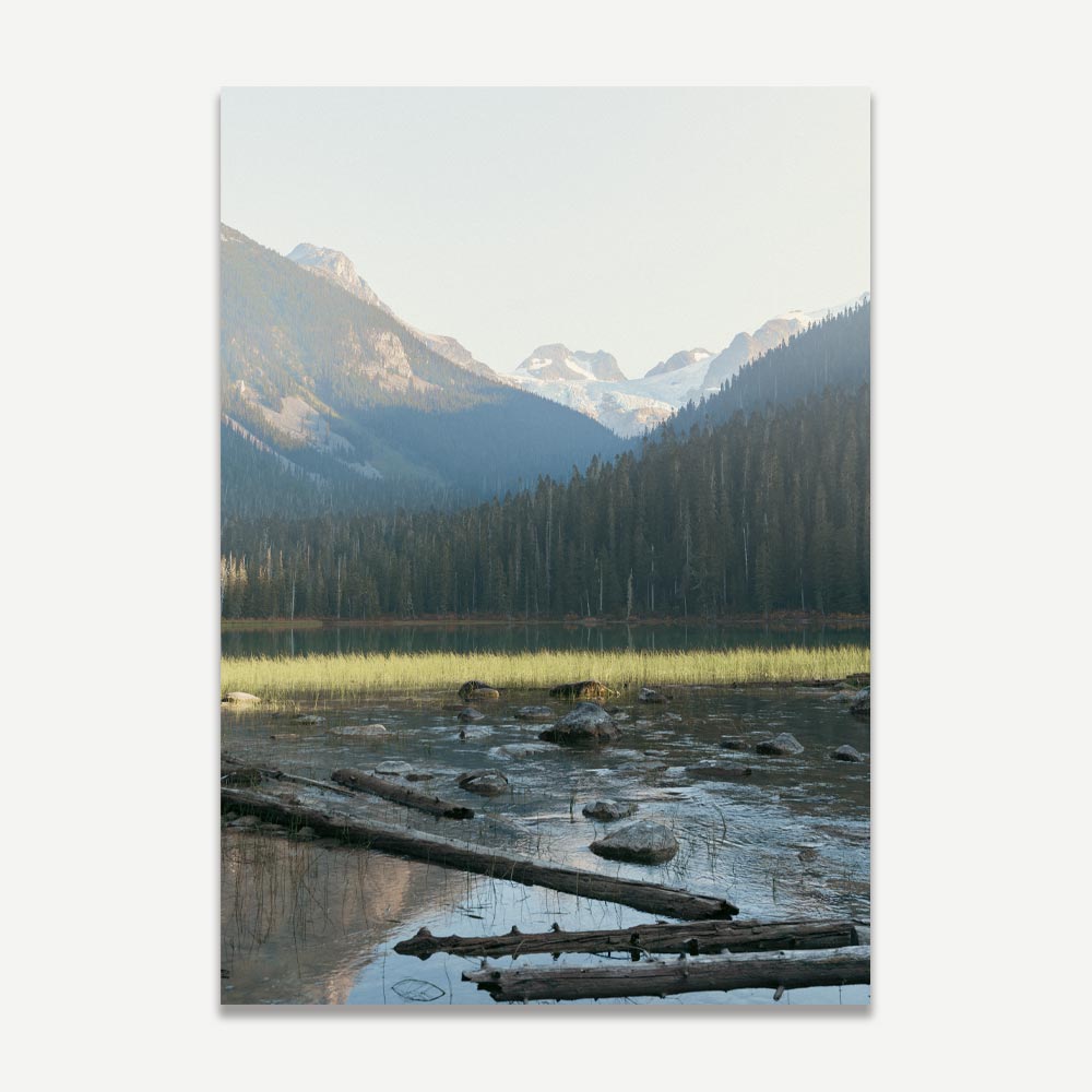 A poster featuring a landscape photograph with a body of water in the foreground and tree-covered mountains in the background under a clear sky.