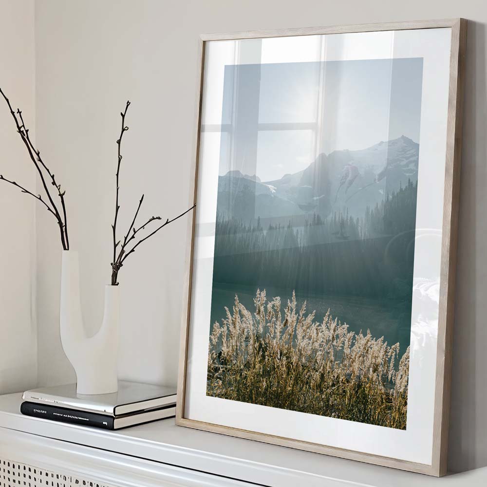 Enhance your living space with this captivating image of a mountain lake, reeds, and a sunlit backdrop - perfect wall decor.