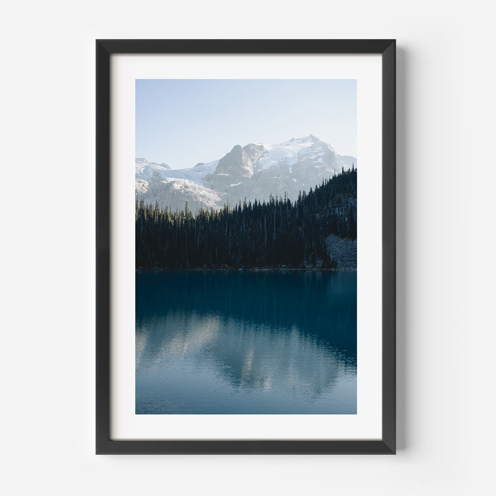 A picturesque scene of Mt. Matier, British Columbia, captured in a framed photo with mountains and a lake.