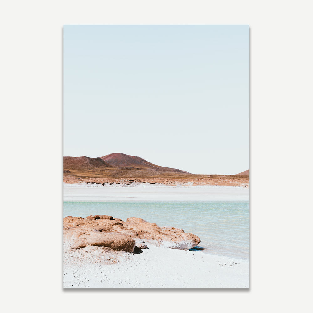 A landscape photograph featuring a remote desert scene with orange and blue colors, the Atacama region in Chile.