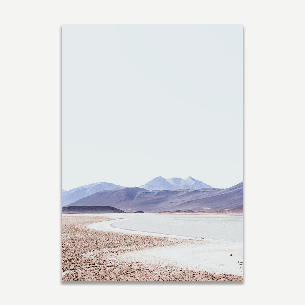 A landscape photograph featuring a desert scene with mountains in the background and a clear sky.