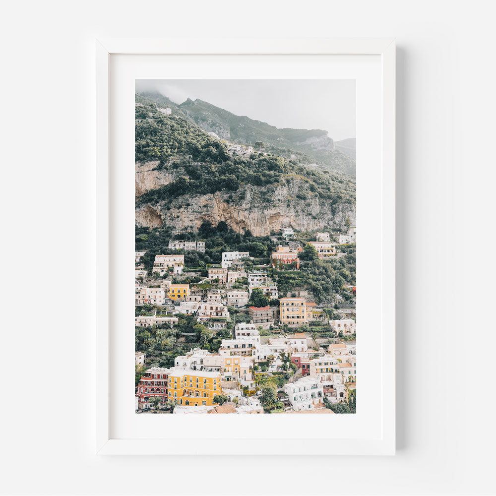 A scenic view of Positano, Italy on the Amalfi Coast with colorful buildings and the Mediterranean Sea in the background.