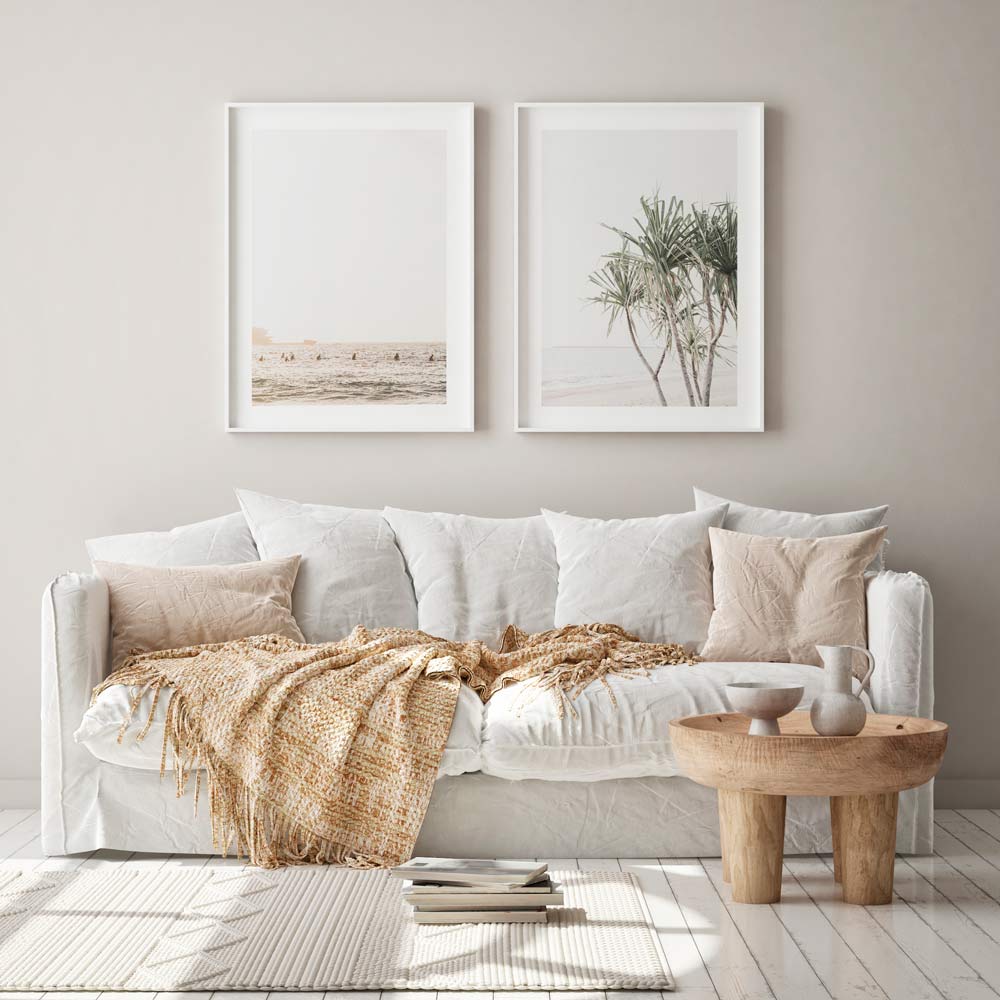 The wall art of coastal inspired theme in white frames hung in living room.