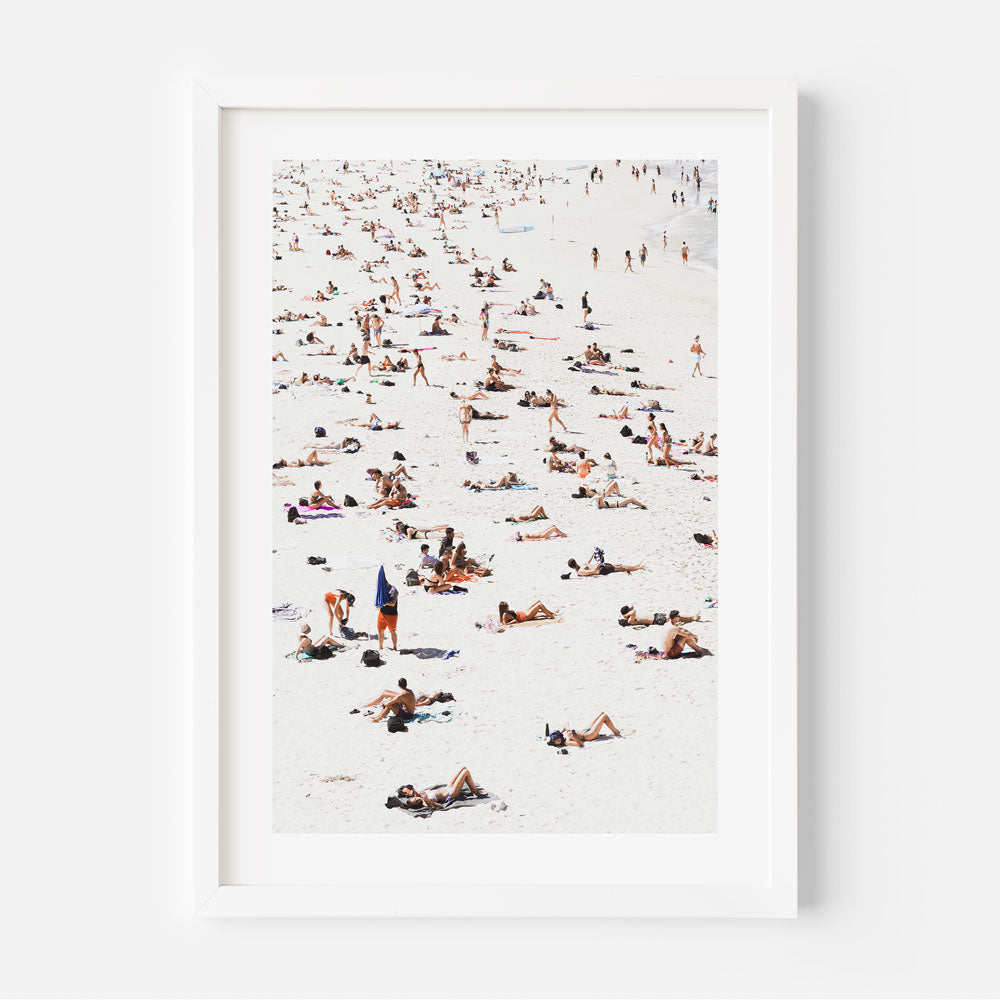 A captivating white framed print capturing people on the beach - perfect wall art for your home or office decor.