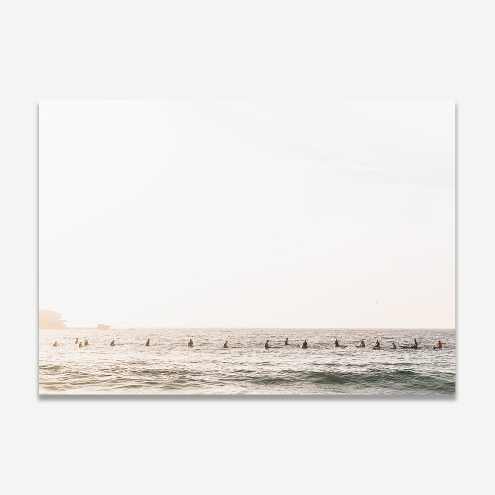 Surfers catching waves in a white framed beach photo.