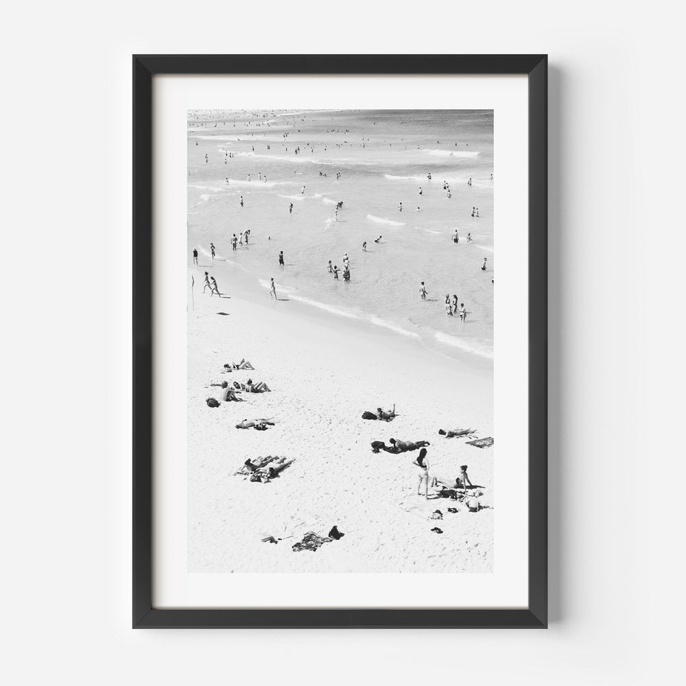 Beachfront Bliss: A framed image of Bondi Beach, featuring vibrant scenes of people soaking up the sun and enjoying the beach atmosphere, perfect for wall art in any beach lover's home.