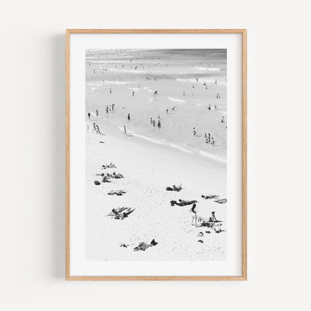 Coastal Getaway: Transport yourself to the shores of Bondi Beach with this framed photo, capturing the carefree moments of bathers and beachgoers, an ideal addition to your coastal-themed decor.