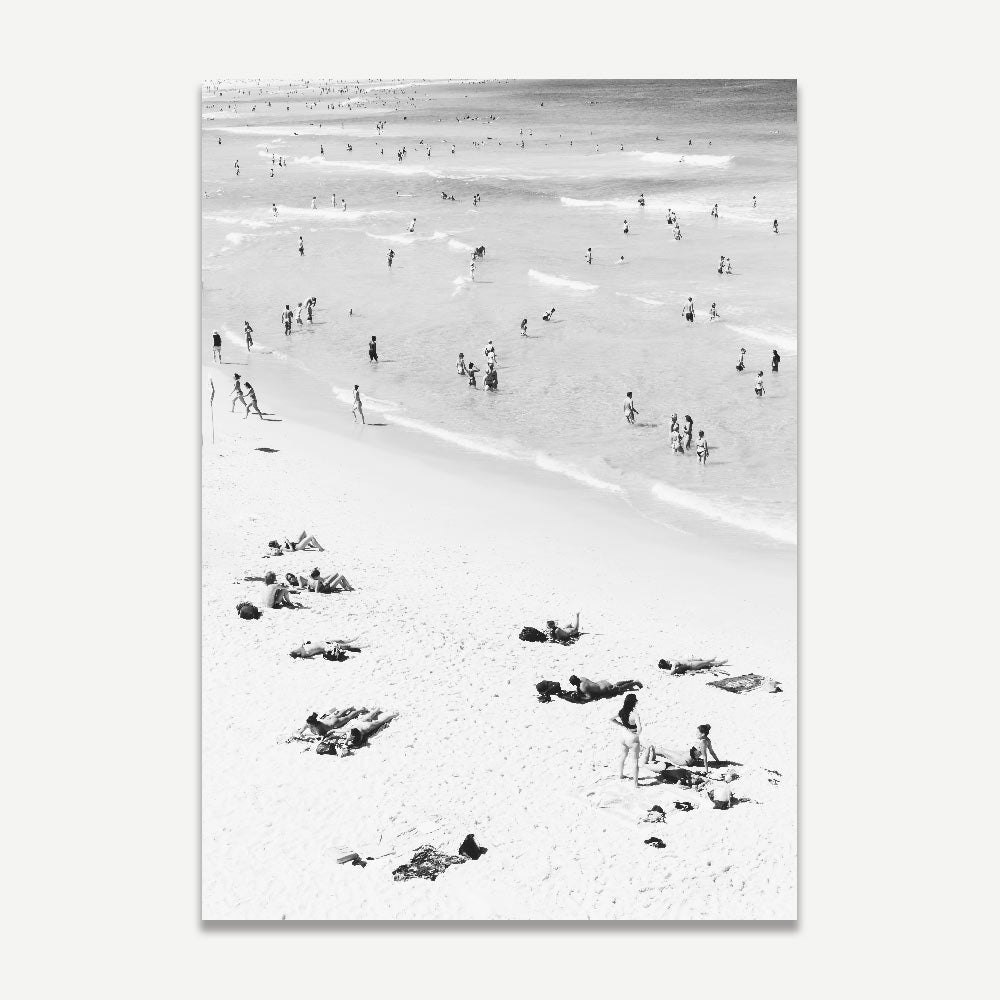 Sun, Sand, and Serenity: This framed photo of Bondi Beach depicts the tranquility of a day by the sea, with people swimming and lounging on the sand, perfect for bringing a beachy vibe into your living space.