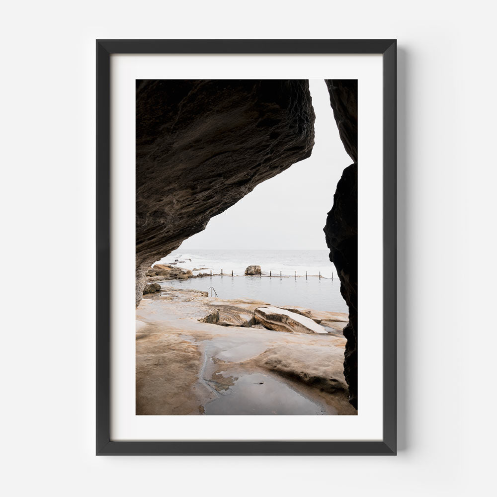 Enhance your living space with this stunning wall art - a framed photo of a beach and rocks from Oblongshop's collection.