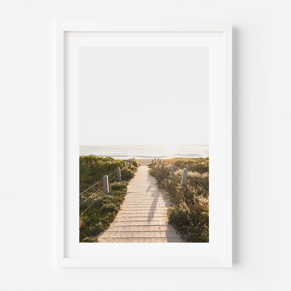 A serene pathway leading to Maroubra Beach, captured in a white framed photo - perfect wall art for your home or office decor.