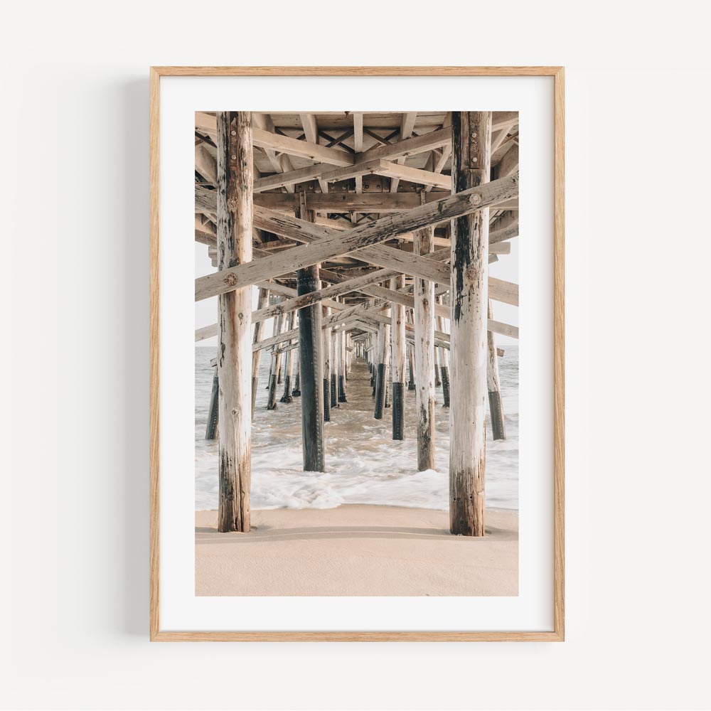 White framed photo of the ocean under a pier - Real photography for wall decor in homes and offices, capturing the beauty of California coast.