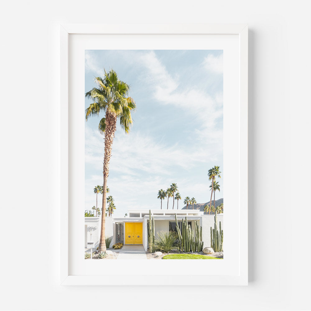 Palm Springs midcentury modern architecture with yellow door, palm trees, and white house - wall art decor
