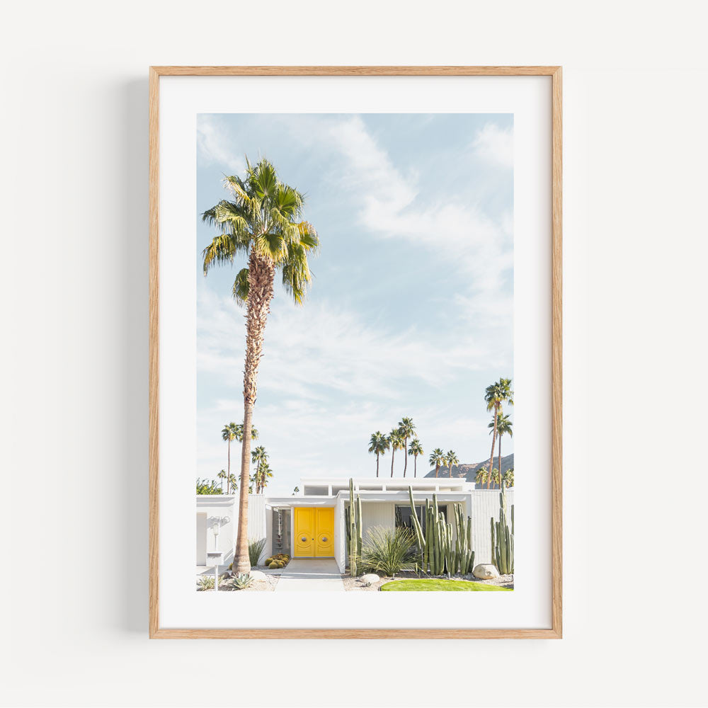 Palm Springs midcentury modern architecture wall art with yellow door, palm trees, and white house